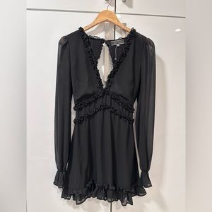 Long sleeved short black dress with ruffle detailing